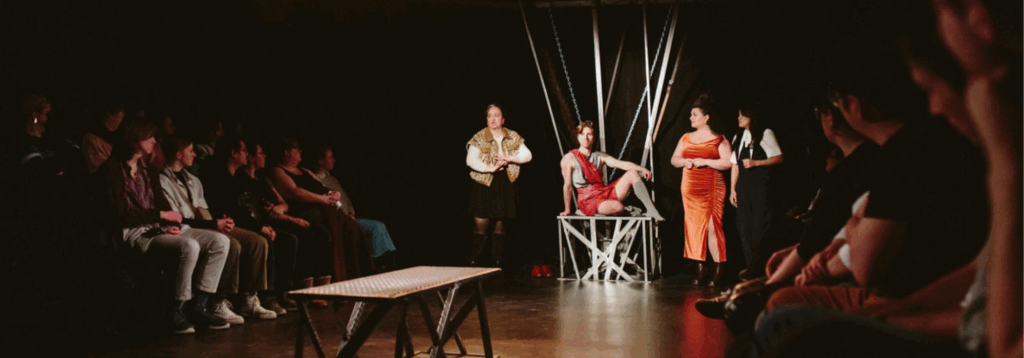 actors performing with audience in the photo as well
